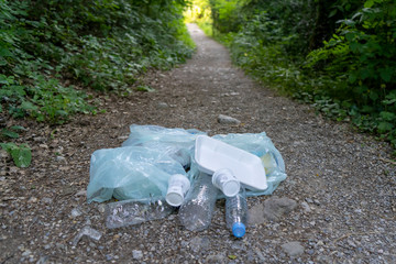 girl collecting plastic in the field, with her mother and grandmother. collect plastic bottles