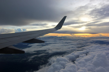 Fototapeta na wymiar aircraft wing flying over beautiful clouds