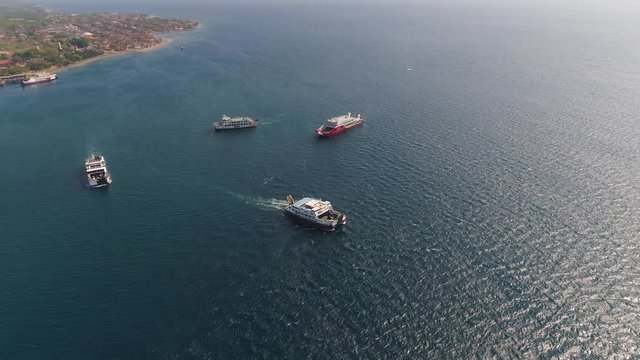 Aerial view ferry port gilimanuk with ferry boats, vehicles. Ferries transport vehicles and passengers in port. Port for departure from Bali to the island of Java. The ferry sails on the sea.