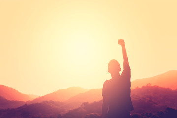 Copy space of man rise hand up on top of mountain and sunset sky abstract background. - obrazy, fototapety, plakaty