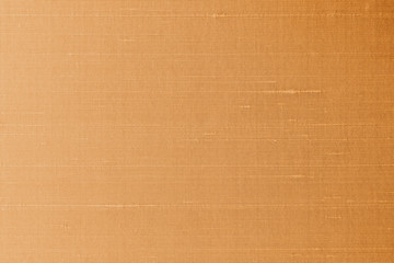 Copper gold silk fabric background of satin texture cotton cloth pattern with shiny gradient silky woven detail