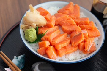 Salmon Donburi or Salmon sushi don, Japanese food on wooden desk background