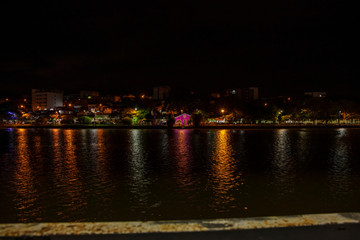 Obraz premium Christmas decoration lights reflected in lake at climate resort in Bragança Paulista region of lakes in Sao Paulo Brazil