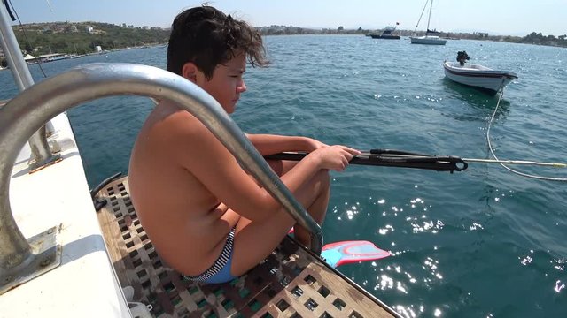 Young boy with spear gun while free diving in Mediterranean sea