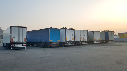 A truck fleet with a trailer, parking at the logistics terminal