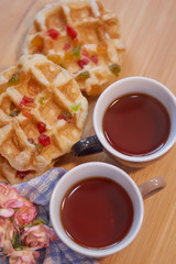 Cups of tea with fruity waffle