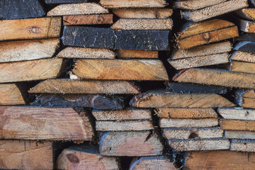 Old woodpile of pine and birch firewood in Siberia
