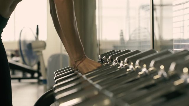 Young athletic woman doing her workout routine at the gym