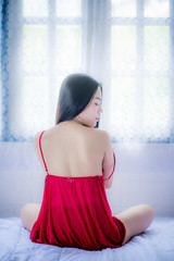 Asian girl in red pyjamas