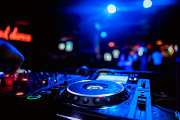 Obraz na płótnie Canvas glowing lights from DJ mixer music remote buttons