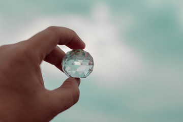 Crystal ball in hand isolated on white background