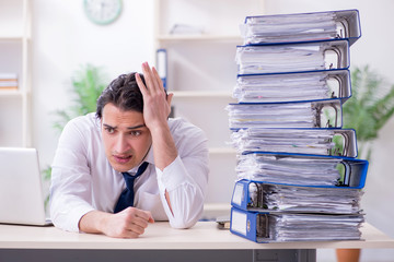 Young male employee unhappy with excessive work