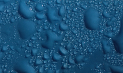 Drops of blue liquid on plastic surface