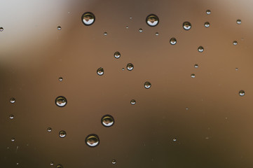 Raindrops on window glass close up. water drops abstract macro background