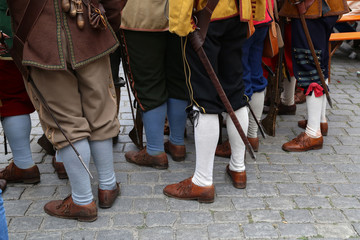 Reconstructors in musketeers clothes on a city holiday