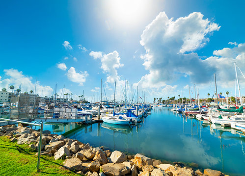 Oceanside harbor under a blue sky with clouds