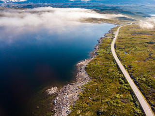 Fototapeta premium Road crossing Hardangervidda plateau, Norway. Aerial view.