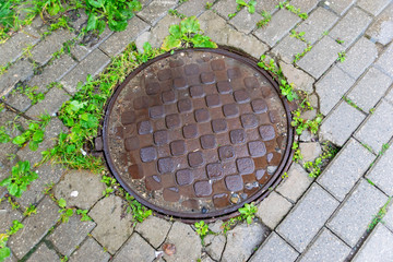 Iron manhole road well