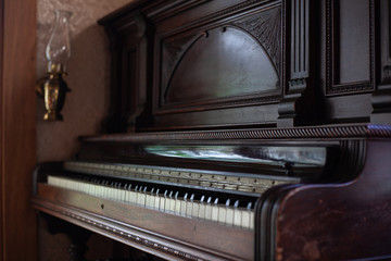 Fototapeta na wymiar closeup keys of an old retro vintage wooden piano in the interior