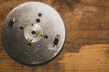 Metal gear on a wood background. detail of mechanism