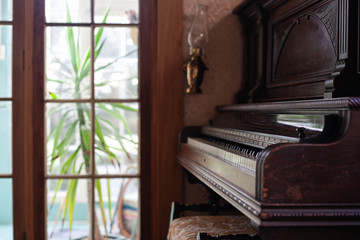 Fototapeta na wymiar close-up old vintage retro dark brown wooden piano in the interior