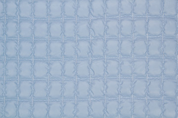 Fabric quilted lilac. The texture of the quilted jackets.