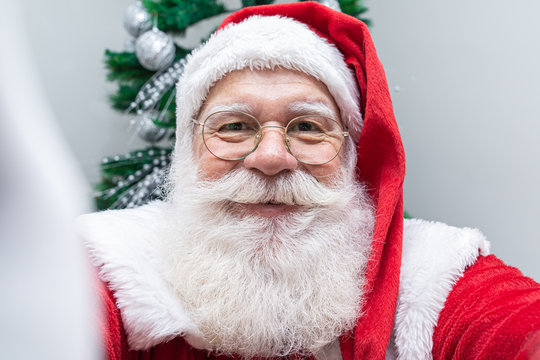 Santa Claus making selfie photos. Christmas night. Gift delivery. Enchanted dreams of children.