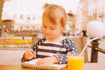 Find your freedom! Humorous portrait of little cute child girl freelancer working outdoors for...