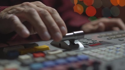 Broadcast Tv Studio Production - Vision Switcher Studio Director broadcast video mixer operation - Close-up of hand