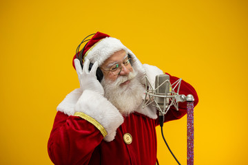 Santa Claus singing or speaking in a studio microphone. Merry Christmas. Broadcaster. Announcer....