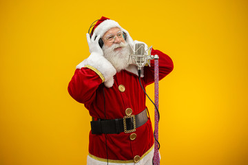Santa Claus singing or speaking in a studio microphone. Merry Christmas. Broadcaster. Announcer....