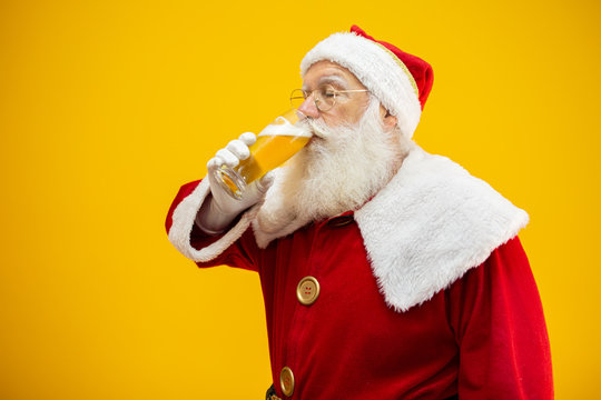 Santa Claus drinking a glass of beer. Rest time. Alcoholic drink at the holidays. Drink with moderation. Craft beer. Merry Christmas.