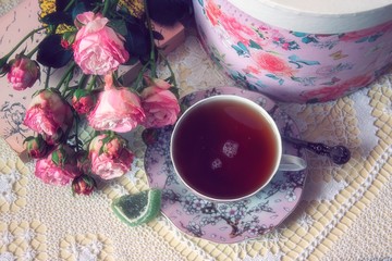 Still life with tea cup and roses in retro style