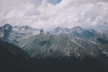 Mountains scene with dramatic cloudy sky in national park of Dombay