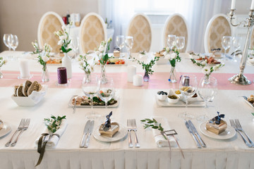 Banquet wedding table in a restaurant or cafe in beige and brown colors. Serving