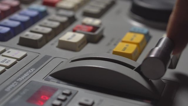 Broadcast Tv Studio Production - Vision Switcher Studio Director broadcast video mixer operation - Close-up of hand
