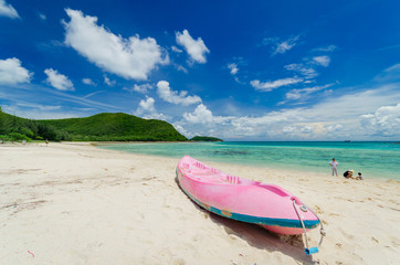 beautiful clear blue sea water on the beach paradise ocean with boat on sand and blue sky cloud. vacation background on summer in Thailand coast.