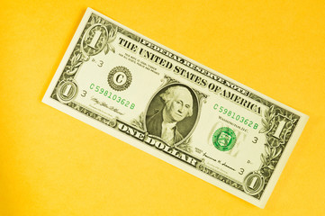 One dollar isolated on yellow background