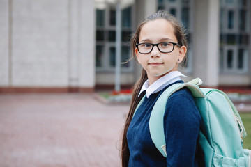 Teenage schoolgirl in uniform in glasses.