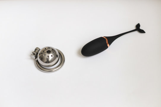 men's chastity belts of different sizes on white background