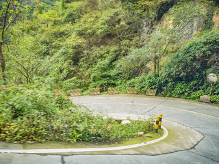 Sharp curve view on the bus on tongtian road moving from tianmen mountain heaven gate cave on tianmen mountain national park at zhangjiajie city China.Tongtian Road the winding Road  99  curves road