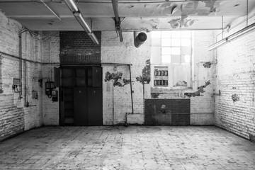 Black and white tone, interior view of  empty abandon room with damaged scratches brick wall and ceiling, broken glass of window, dirty tile floor, with nobody.