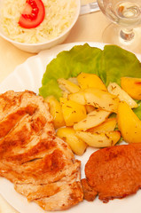 fried pork and chicken with fries and cabbage salad