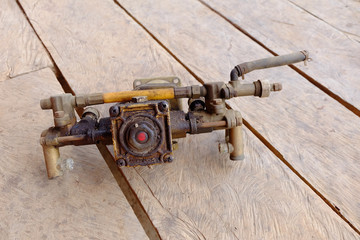 Old pump spare parts on the wood background.