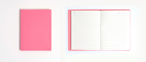 Pink notebook on white desk. Business minimal concept for women. Flat lay, top view, copy space