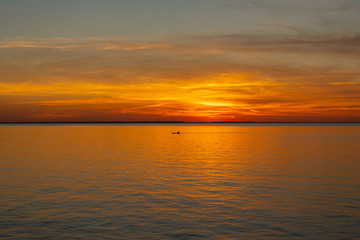 Fototapeta na wymiar Kayaking into the Sunset over Lake Ontario
