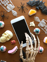 Skeleton using smartphone in Halloween