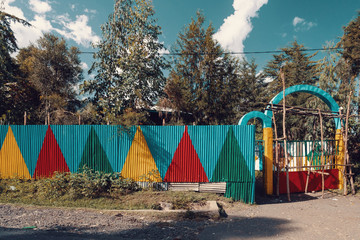 Color painted corrugated iron fence at a school in Ethiopia