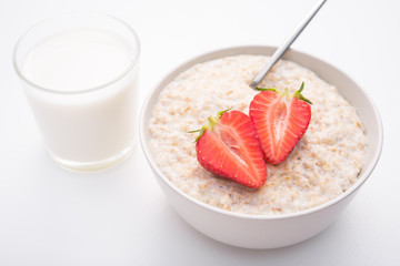 Sweet porridge with red strawberry