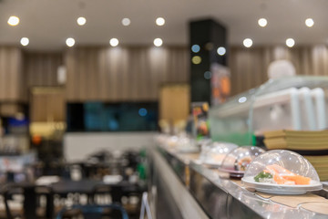 Japan restaurant sushi conveyor or belt buffet. belt sushi in japan restaurant with blurred...